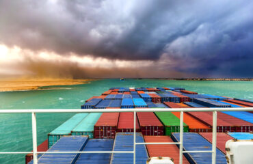 A view over the top of a shipping container heading into a storm in the Suez Canal in the Red Sea, one of the world's busiest shipping lanes.